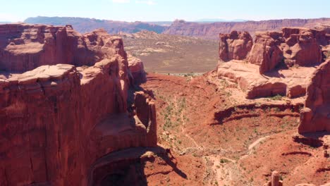 4K-aerial-of-rock-formations-in-a-desert-landscape---Arches-National-Park,-Utah,-USA