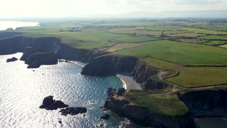 cliffs-in-Ireland-with-beach-and-blue-sea