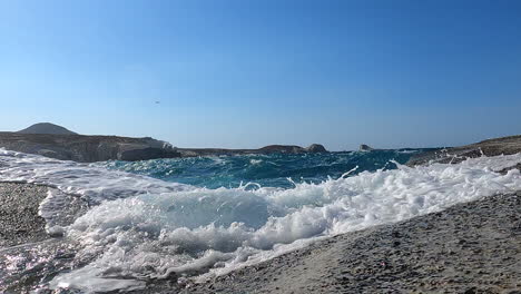 splashing-water-on-a-Greek-rocky-shore-windy