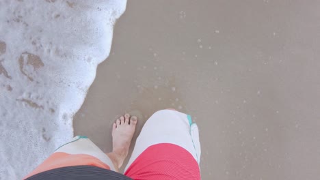 POV-of-man-walking-with-barefoot-on-white-sand-beach-in-slow-motion-in-summer-holiday-vacation