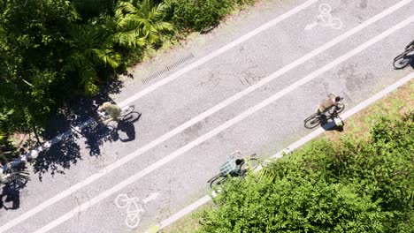 Bicycles-with-bicyclists-moving-on-a-bicycle-road
