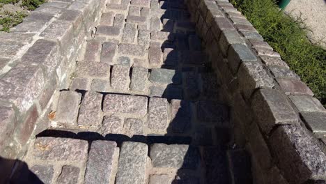 Person-Walking-Down-At-The-Cobblestone-Stairway-On