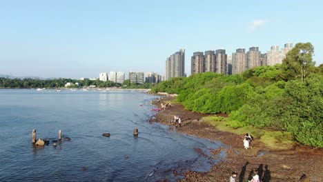 Hong-Kong-Wu-Kai-Sha-beach-and-coastline-with-residential-skyscrapers-in-the-background,-Aerial-view