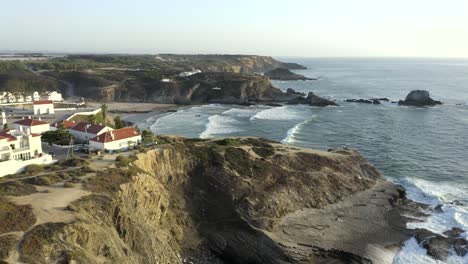 calm-shot-overlooking-the-edge-of-town-and-the-cliffs-at-Zambujeira-do-Mar,-Portugal