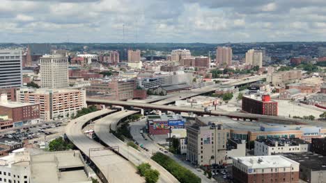 Aerial-of-interstate-highway,-cuts-through-Baltimore-city,-office-buildings-and-businesses-in-United-States-of-America,-USA