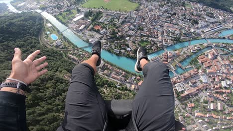 Amazing,-epic-and-colorful-POV-view-from-a-paragliding-ride-over-a-small-and-pretty-village-in-the-Swiss-alps