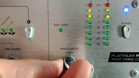 An-audio-device-with-knobs-and-vertical-LED-level-meters