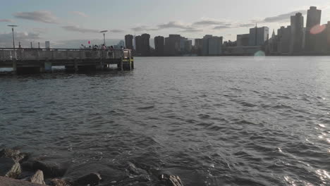 Wide-shot-of-East-Side-of-New-York-City-from-Queens-and-river-dock