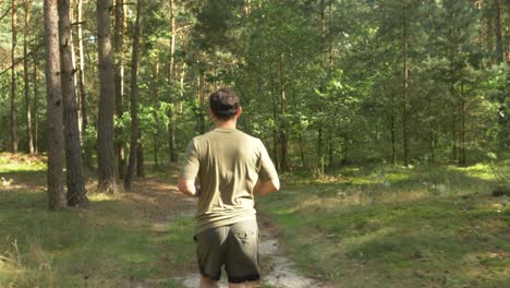 Morning-Run---Healthy-Adult-Man-Running-Through-The-Woods-In-Arendel,-Zagorow,-Poland---Tracking-Shot