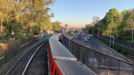 Elevated-trains-on-their-morning-commute-alongside-Tlalpan-Avenue-in-the-southern-part-of-Mexico-City,-Mexico