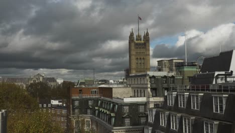 Rooftop-View-Of-Victoria-Tower-In-London-With-Flag-Against-Dramatic-Clouds
