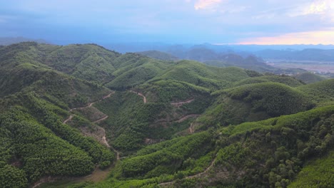 Drone-shot-moving-backward-from-mountain-range-in-Phong-Nha