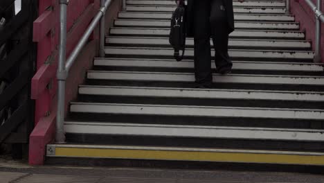 Business-woman-descends-steps-in-urban-train-station