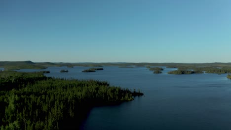 Aerial-shot-over-a-blue-and-wild-lake-in-northern-Quebec-province-in-Canada