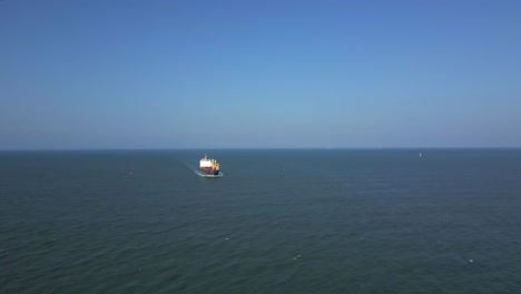 Aerial-View-of-Tanker-Ship-Approaching-the-Coast,-Sunny-Day-Seascape
