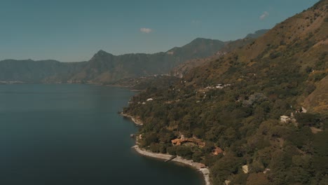 Drone-aerial-view-of-lake-Atitlan-and-San-Marcos,-Guatemala,-Central-America