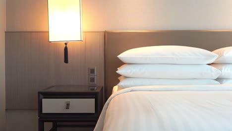 Hotel-Room-Accommodation,-King-Size-Bed-in-Master-Suite,-White-Sheets-and-Pillows-Pan-Left