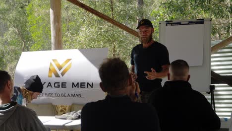 Man-Standing-And-Talking-In-Front-Of-Male-Audience---Manhood-Training---Gold-Coast,-Queensland,-Australia