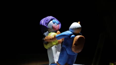 Polymer-Clay-Figure-Of-Two-Friends-Holding-Hands-And-Spinning-Together---Character-In-Outer-Space-Concept---studio-shot