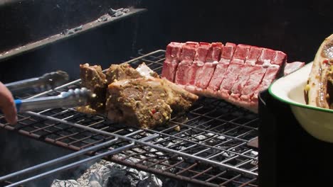 Grilling-chops-and-lamb-on-a-barbecue,-braai
