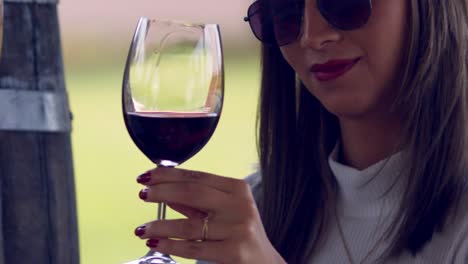 Classy-rich-fashionable-woman-toasting-red-wine-then-drinking-it-in-slow-motion