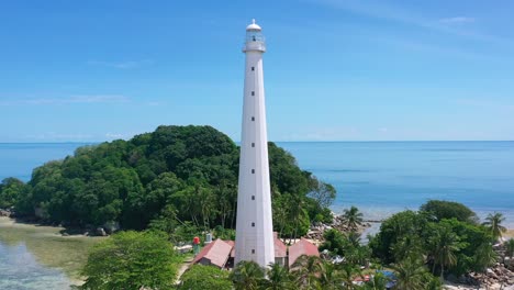 aerial-of-tourists-on-white-sand-beach-with-white-lighthouse-on-lengkuas-island