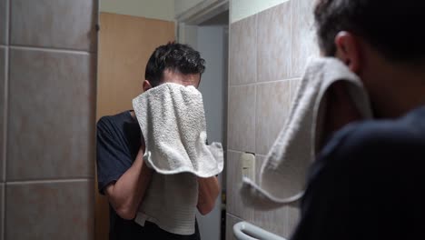 Man-Drying-His-Wet-Face-With-Towel-After-Washing-In-The-Bathroom