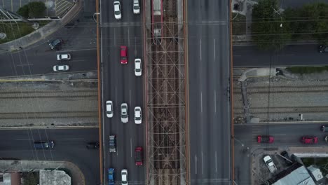 aerial-train-going-around-and-below-cars-and-train-rails