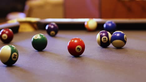 Colorful-Billiard-Balls-Rolling-On-The-Pool-Table---close-up