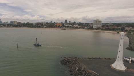 Drone-aerial-by-the-St-Kilda-lighthouse-in-Melbourne-with-a-boat-on-the-water