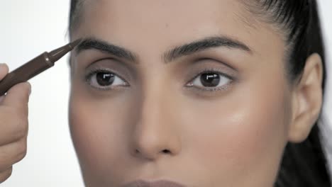 Makeup-Artist-Painting-Models-Eyebrow-With-A-Makeup-Pencil