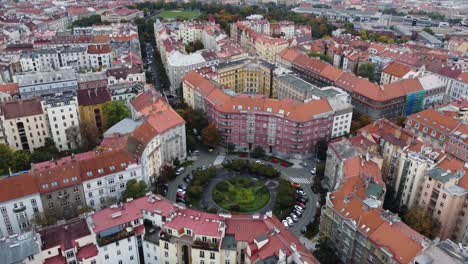 Aerial-drone-view-of-Skroup-Square-in-Zizkov,-Prague-Czech-Republic,-ascending-tilting-up-panoramic-shot