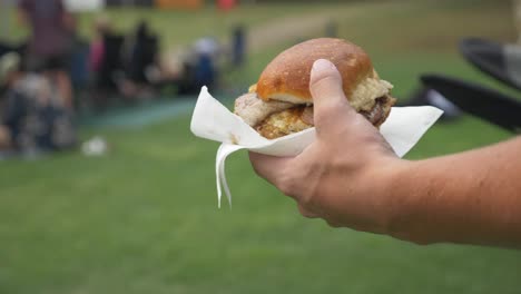 Close-up-on-a-burger-being-carried-during-an-event