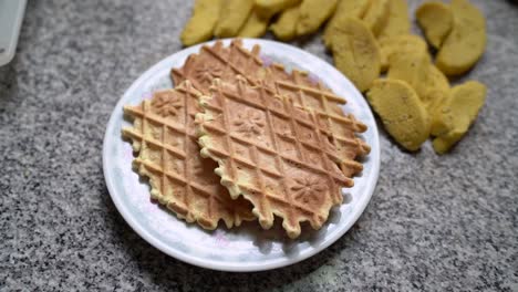 Stack-Of-Pizzelles,-Traditional-Italian-Waffle-Cookie-Served-On-Plate-In-The-Kitchen