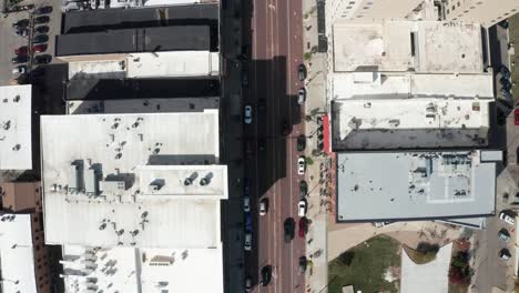 Downtown-Flint,-Michigan-overhead-drone-shot-following-car