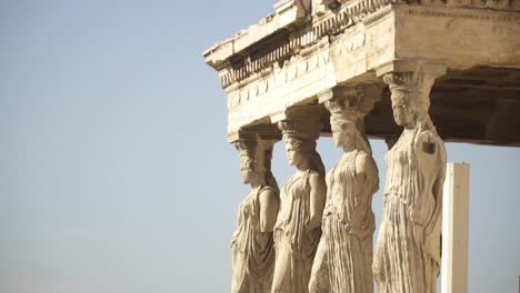 Close-view-of-the-outer-statues-of-Cariátides-and-Acropolis-in-Athens-Greece