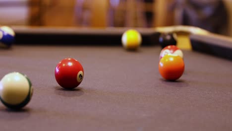 Playing-A-Game-Of-Pool-With-Balls-Rolling-Over-Billiard-Table