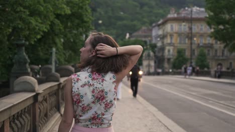 Woman-walking-in-Prague-city-and-turning-to-camera,-optimistic-smile,-pretty-face-closeup-view
