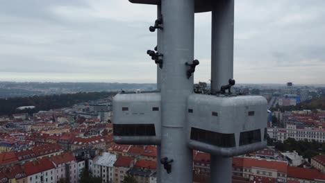 Prague-Zizkov-Tower-drone-closeup-ascending-view-of-viewpoint-or-observatory,-hotel-and-restaurant,-popular-landmark-in-capital-city-of-Czech-Republic