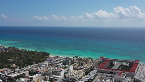 Aerial-shot-heading-the-sea-shows-buildings-and-big-hotel-by-the-Caribbean