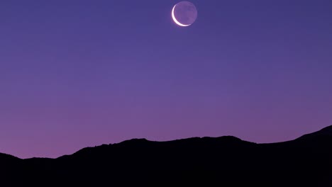 Stunning-Moonrise-Over-Mountain-in-Twilight-Dark-Night-Time-and-Pink-Night-Sky-Before-Sun-Rise-in-Iran