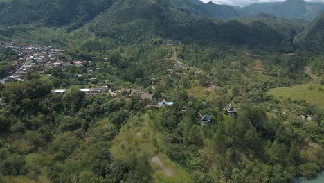 Drone-aerial-green-landscape-view-of-mountains-and-town-in-Lanquin-Guatemala