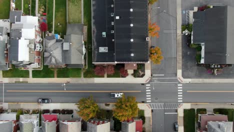 Aerial-top-down-tracking-shot-of-car-driving-on-street