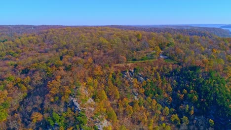 Aerial-View-of-Autumn-Tree-Colors-Along-a-Major-River-on-a-Sunny-Fall-Day