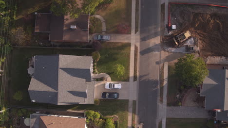 Overhead-view-of-suburban-street-at-sunset-with-new-construction-camera-pushes-up-the-street