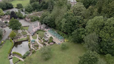Quaint-English-Cockington-village-aerial-view-over-idyllic-thatched-cottage-landscaped-gardens