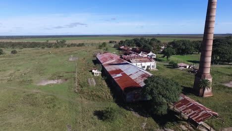 Aerial-View-of-Old-Abandoned-Factory-and-Chimney-in-Rural-Landscape-of-Argentina