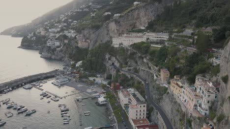 Aerial-view-of-Amalfi,-scenic-city-in-mouth-of-deep-ravine-by-Mediterranean-sea,-Italy