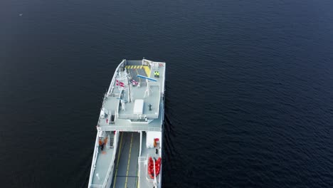 Flying-over-electric-car-ferry-at-sea---Birdseye-aerial-Norway