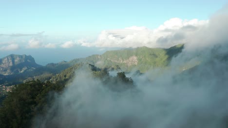 Aerial-of-magical-lush-mountains-of-Madeira-covered-in-clouds,-Balcoes
